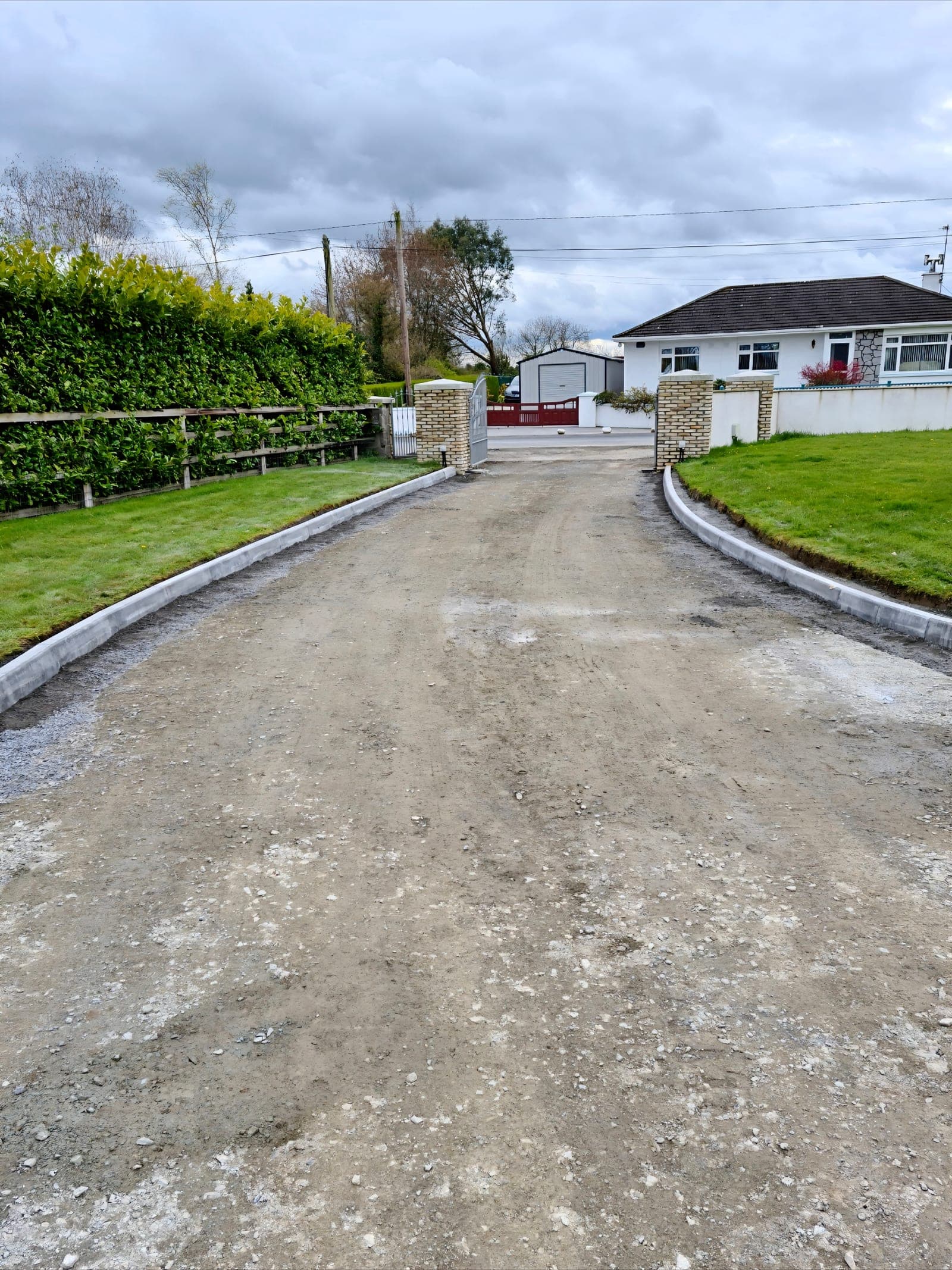 Driveway excavated and levelled to a compacted stone sub-base between newly set kerbs